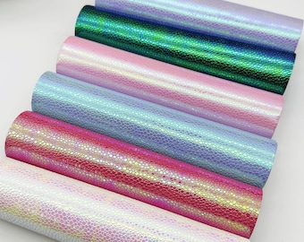 May include: Six rolls of iridescent faux leather in various colors, including white, pink, blue, green, and red. The leather has a textured, scaly pattern.