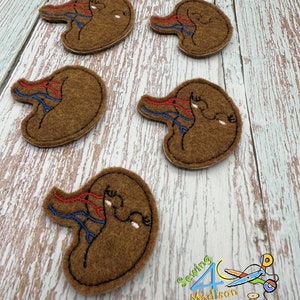 May include: Five brown felt patches with red and blue embroidery depicting a stylized human kidney.
