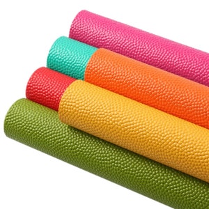 May include: A collection of colorful, textured rolls of material. The rolls are in shades of green, yellow, orange, red, teal, and pink. The material has a bumpy, pebble-like texture. The rolls are tightly wound and appear to be made of a flexible material.