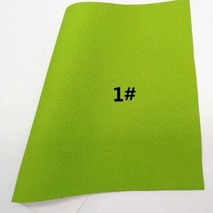 May include: A sheet of bright green textured material with the number "1#" printed in black. The material has a slightly curved shape and a white surface is visible at the bottom.