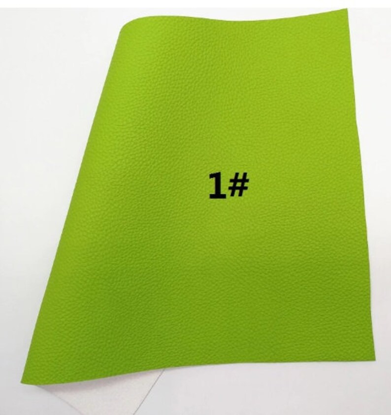 May include: A sheet of bright green textured material with the number "1#" printed in black. The material has a slightly curved shape and a white surface is visible at the bottom.