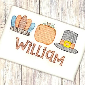 May include: Embroidered design featuring a pilgrim hat, a pumpkin, and a Native American headdress with the name "William" underneath.