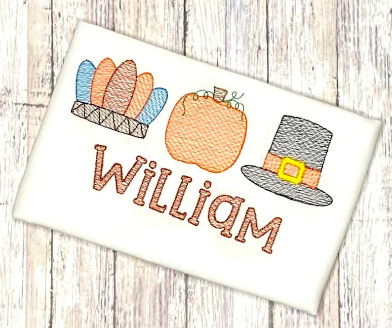 May include: Embroidered design featuring a pilgrim hat, a pumpkin, and a Native American headdress with the name "William" underneath.
