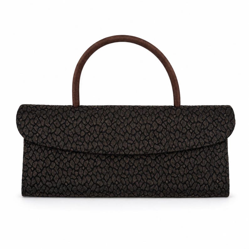 May include: A rectangular black handbag with a brown handle. The bag has a textured pattern and a flap closure. The handle is arched and made of a darker brown material.