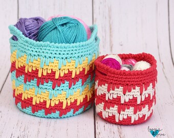May include: Two crocheted baskets, one teal and one red, with colorful yarn balls inside. The baskets have a textured, striped pattern. The text "Loops & Love" is visible in the bottom right corner.