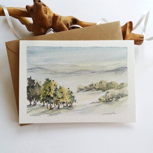 Cartão pintado à mão. Paisagem de prado nevado. Mini pintura de paisagem em aquarela