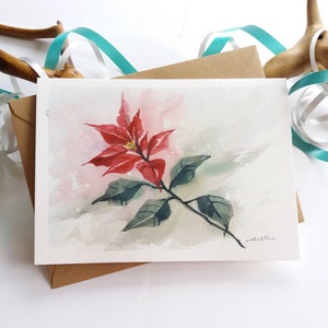 Cartolina di Natale dipinta a mano. Fiore di Natale della stella di Natale. Carta acquerello. Mini pittura artistica