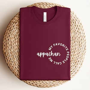 May include: Burgundy t-shirt with white text that reads "My favorite people call me appalachan".