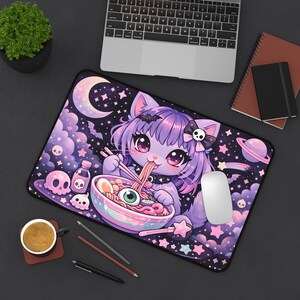 May include: A rectangular mousepad featuring a purple anime cat eating ramen. The design includes a crescent moon, stars, skulls, and a planet. The cat has purple hair and is wearing a black collar with a skull. The mousepad is on a black surface.
