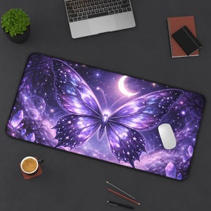 May include: A large rectangular desk mat featuring a purple butterfly design with a starry night sky background. The butterfly has detailed wing patterns and is centered on the mat. A white computer mouse is on the right side.