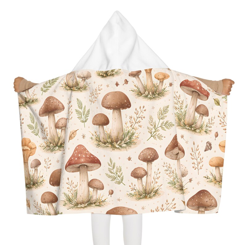 May include: A white ceramic mug with a black handle and the text "But First, Coffee" in a bold, black font. The mug is set against a blurred background. The mug appears to be approximately 10 cm tall.