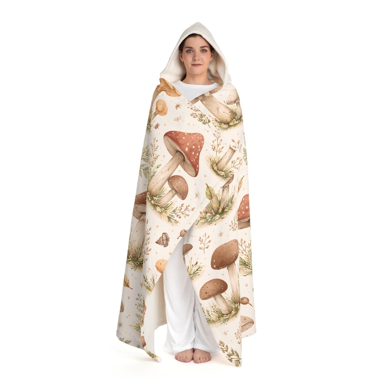 May include: A set of three ceramic mugs with a speckled, cream-coloured glaze. Each mug features a different hand-painted floral design in shades of blue, green, and yellow. The mugs have a simple, modern shape.