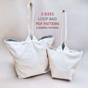 Peut inclure: Deux sacs cabas en toile avec des anses en boucle. Le plus grand sac a une doublure rayée noir et blanc. Le texte sur l'image est "2 SIZES LOOP BAG PDF PATTERN & SEWING TUTORIAL".