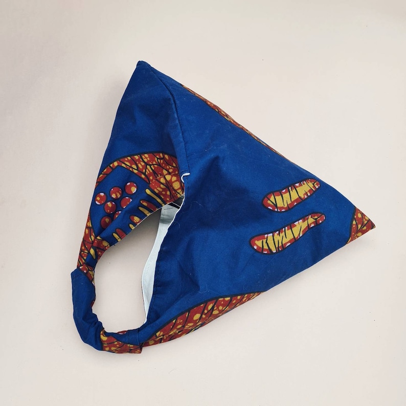 May include: A blue and orange fabric tote bag with a unique design. The bag has a single handle and is made of a sturdy fabric.