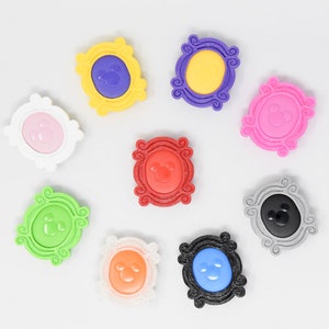 May include: Nine colorful plastic picture frames with a Mickey Mouse silhouette inside each frame. The frames are in various colors including pink, yellow, red, green, blue, black, and gray.