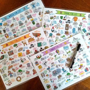 May include: Four laminated sheets with colorful illustrations of activities for each season. The sheets are titled "Winter Fun List", "Fall Fun List", "Spring Fun List", and "Summer Fun List". Each sheet has a list of activities with corresponding illustrations. A white dry-erase marker is on top of the sheets.