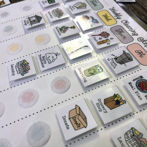 May include: A white weekly cleaning schedule chart with colourful squares and icons for each day of the week. The icons include a broom, a bin, a recycling bin, a shopping bag, a laundry basket, and more. The chart is designed to help people stay organised and on top of their cleaning tasks.