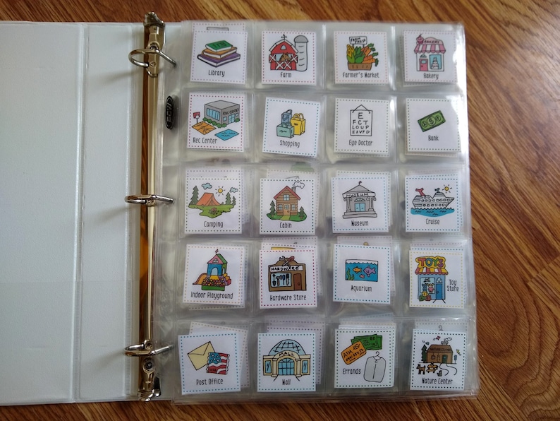 May include: A clear binder with colorful picture cards inside. Each card has a picture of a place, such as a library, farm, farmer's market, bakery, rec center, shopping, eye doctor, bank, camping, cabin, museum, cruise, indoor playground, hardware store, aquarium, toy store, post office, mall, errands, and nature center.