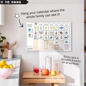 May include: A white weekly calendar with colorful illustrations for each day of the week. The calendar is hanging on a white wall with a star sticker and the text "Easy to Hang" above it. The text "Hang your calendar where the whole family can see it!" is written on the wall. The text "Sticky tack is included & works on all surfaces" is written below the calendar.