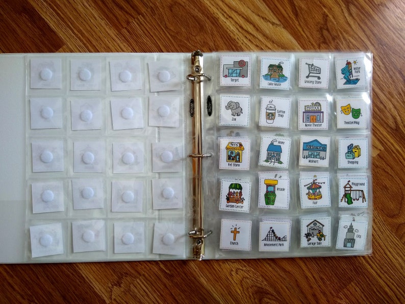 May include: A binder with clear plastic pockets containing small, colorful pictures of various places and activities. The pictures include a grocery store, a park, a zoo, a coffee shop, a movie theater, a church, an amusement park, a playground, a shopping mall, a library, a garden center, a restaurant, and a gas station.