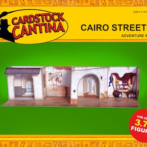 May include: Cardstock Cantina Cairo Streets Adventure Set, a papercraft model kit for building a 3.75 inch scale model of a Middle Eastern street scene. The model features a building with a shop and a bar, and is designed for use with action figures.