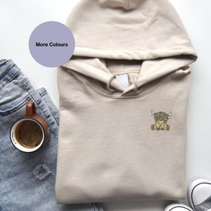 Scottish highland cow organic hoodie. Embroidered highland cow gift ideas. Unisex hoodie. Hoodie gift ideas. embroidered gift ideas. cow lovers gift ideas