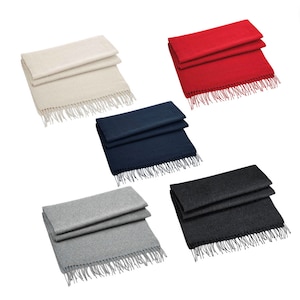 May include: Five different colored scarves with fringe. The scarves are folded in half and laid out on a white background. The colors are beige, red, navy blue, gray, and charcoal.