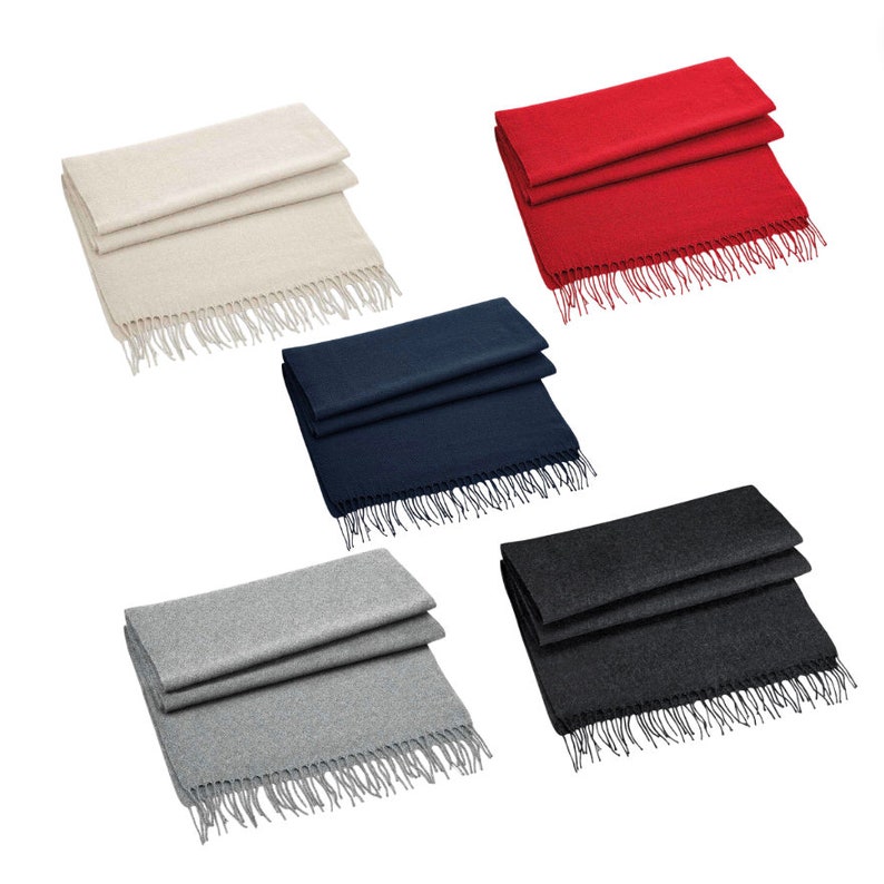 May include: Five different colored scarves with fringe. The scarves are folded in half and laid out on a white background. The colors are beige, red, navy blue, gray, and charcoal.