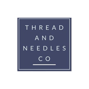 May include: A navy blue square with a white border and the text "THREAD AND NEEDLES CO" in white.