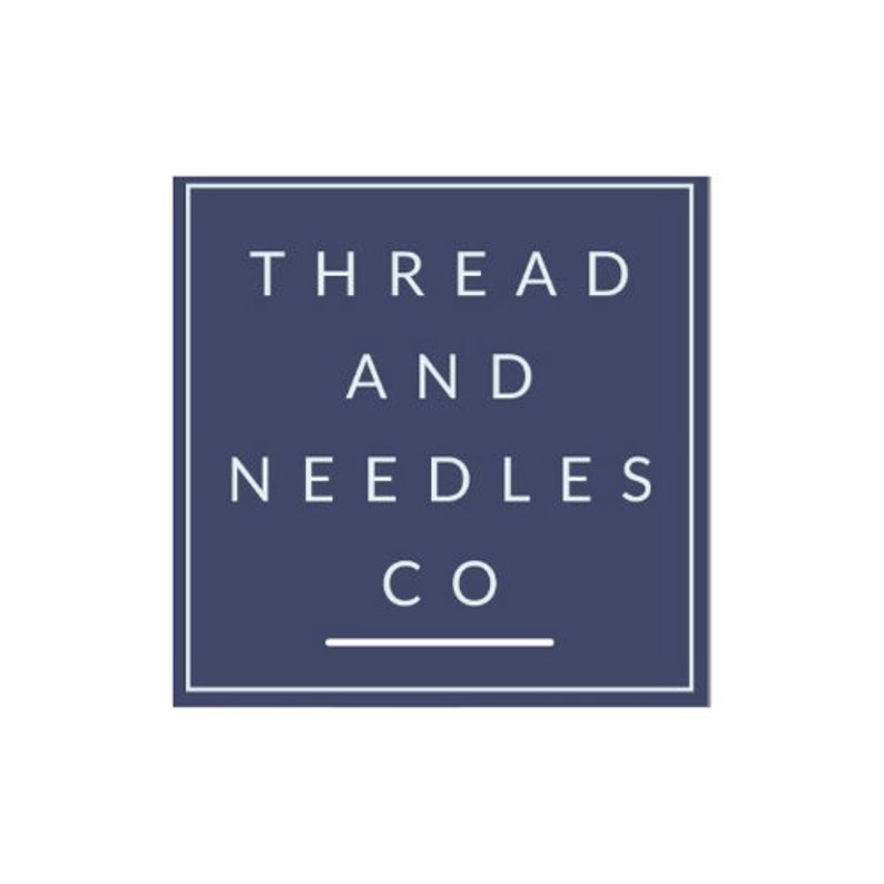 May include: A navy blue square with a white border and the text "THREAD AND NEEDLES CO" in white.