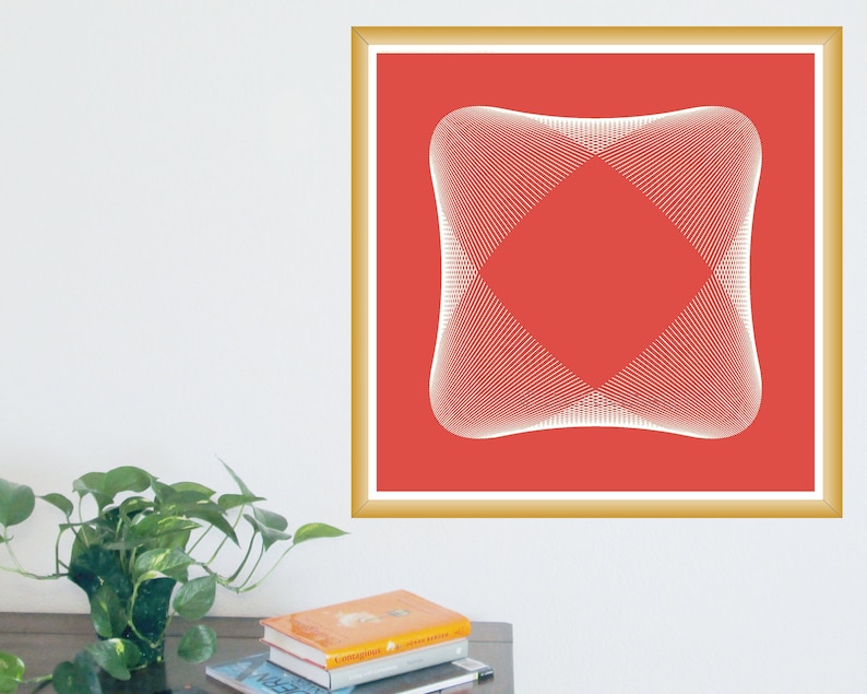 May include: A framed art print featuring a geometric design. The artwork has a red background with a white, symmetrical, abstract shape in the center. The frame is gold-colored, and the print is hanging on a white wall.