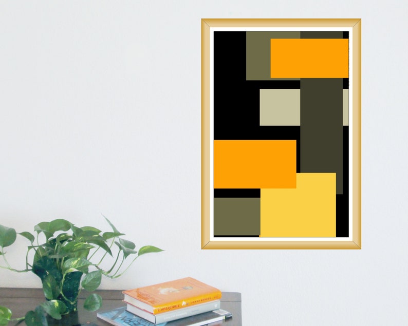 May include: Abstract art print in a gold frame. The artwork features a geometric design with rectangular and square shapes in shades of orange, yellow, black, and olive green. The print is displayed on a white wall.