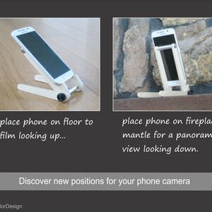 May include: A white phone stand with a black adjustment knob, holding a smartphone. The stand is shown on a wooden floor and a fireplace mantel. Text reads: "place phone on floor to film looking up..." and "place phone on fireplace mantle for a panoramic view looking down."