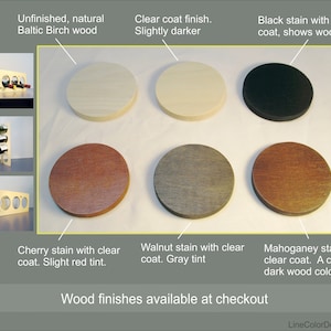 May include: Image showcasing various wood finishes for wine racks. Options include unfinished Baltic Birch, clear coat, black stain, cherry stain, walnut stain, and mahogany stain. The text reads "Wood finishes available at checkout."