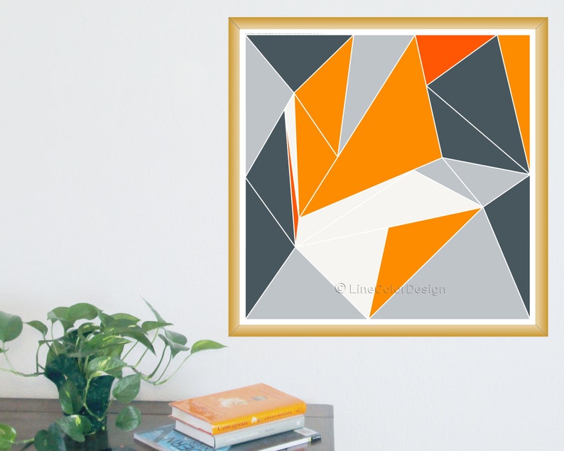 May include: Geometric abstract art print in a gold frame. The artwork features a design of orange, grey, white, and dark grey geometric shapes. The artwork is signed "LineColorDesign".