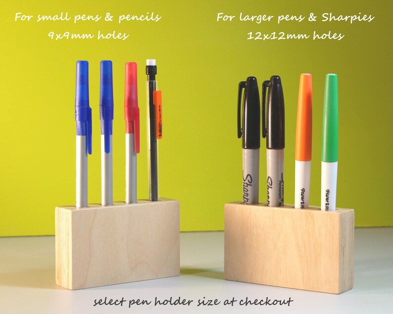 May include: Wooden pen holders with pens and markers. One holder is for small pens and pencils with 9x9mm holes, and the other is for larger pens and Sharpies with 12x12mm holes. The text says "select pen holder size at checkout."
