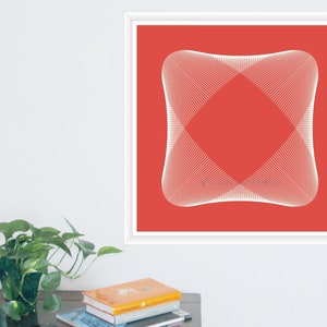 May include: Square framed art print featuring a geometric design. The artwork showcases a white, symmetrical pattern against a red background. The print is displayed on a white wall, with a small plant and books visible in the foreground.