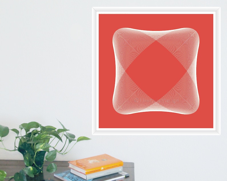 May include: Square framed art print featuring a geometric design. The artwork showcases a white, symmetrical pattern against a red background. The print is displayed on a white wall, with a small plant and books visible in the foreground.