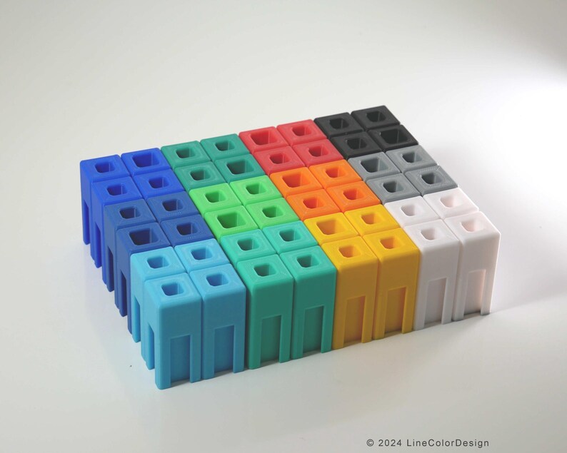 May include: A collection of colorful, modular building blocks in shades of blue, green, red, orange, yellow, gray, black, and white. Each block has a square top with four holes and a rectangular base with vertical supports. The blocks are arranged in a grid pattern.