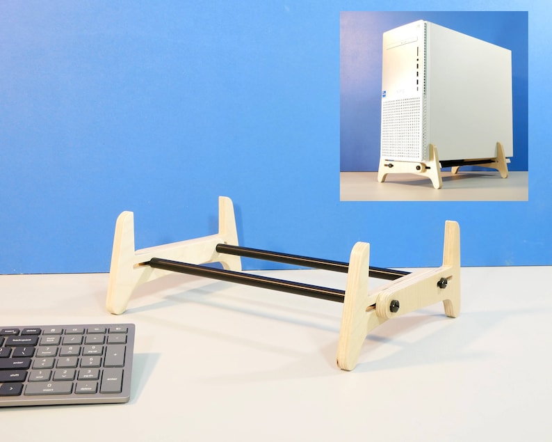 May include: A wooden computer stand with a natural finish and black support rods. The stand is designed to elevate a desktop computer tower, promoting airflow. The stand is shown with a computer tower and a keyboard.