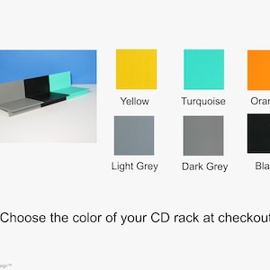 May include: A CD rack in various colors: yellow, turquoise, orange, light grey, dark grey, and black. The image also shows a CD rack in light grey, black, and turquoise. Text reads: "Choose the color of your CD rack at checkout."