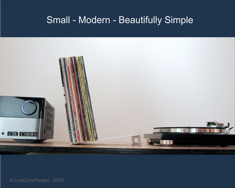 May include: A modern audio setup featuring a silver and black stereo receiver, a turntable, and a stack of vinyl records. The image includes the text "Small - Modern - Beautifully Simple."