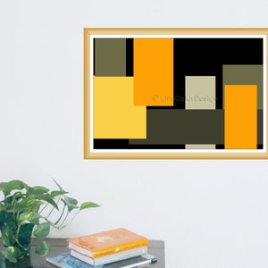 May include: A framed abstract art print featuring a geometric design. The artwork showcases overlapping rectangles in shades of yellow, orange, black, and olive green. The print is in a gold-colored frame and is displayed on a white wall.