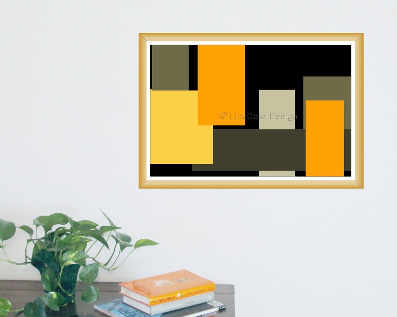 May include: A framed abstract art print featuring a geometric design. The artwork showcases overlapping rectangles in shades of yellow, orange, black, and olive green. The print is in a gold-colored frame and is displayed on a white wall.