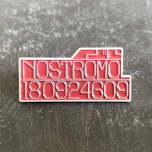 May include: A red enamel pin with white outlines featuring the text "Nostromo 180924609".