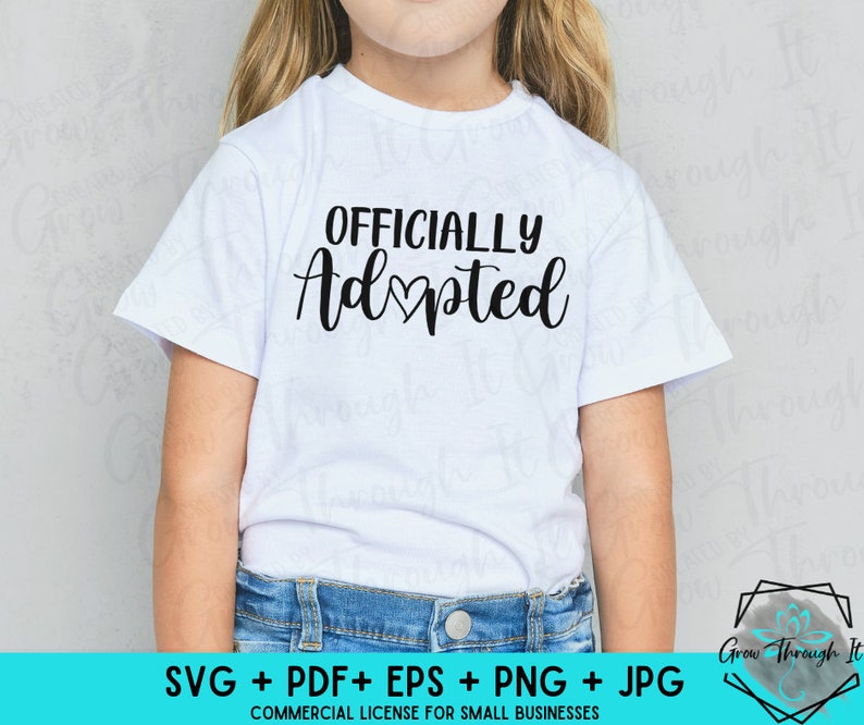 May include: A white t-shirt with the text "OFFICIALLY Adopted" in black lettering with a small heart in the middle of the word "Adopted".