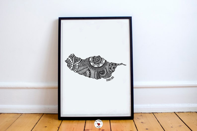 May include: A black and white line art print of the island of Madeira, Portugal. The island is filled with intricate patterns and designs. The word "Madeira" is written at the bottom of the print.