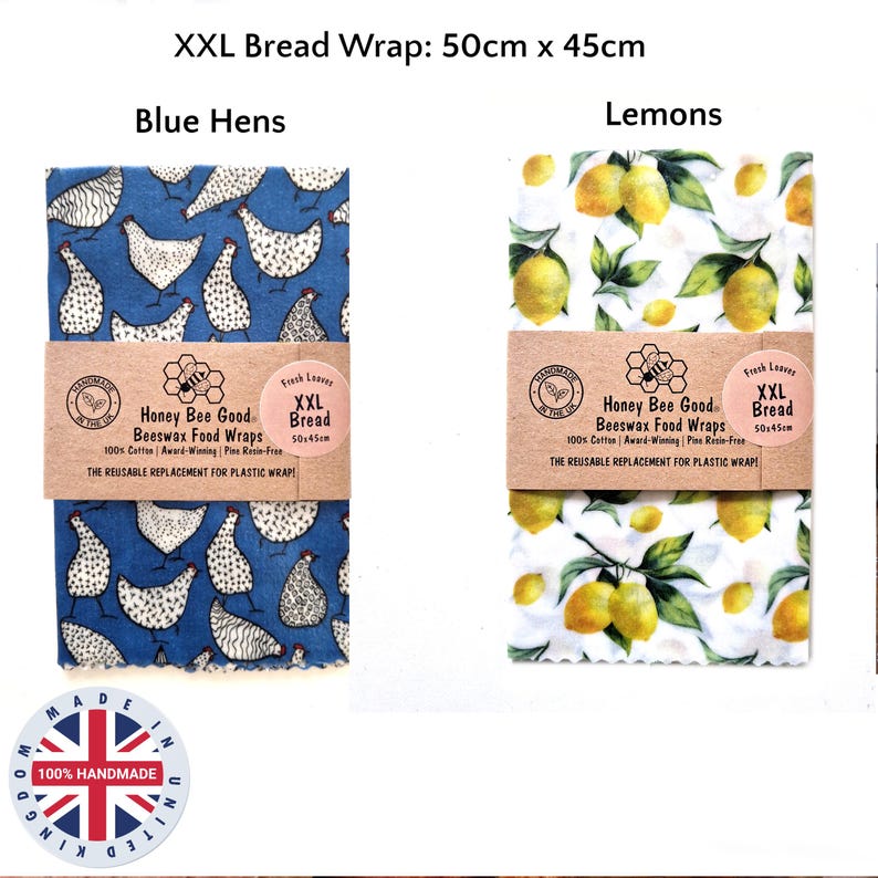 May include: Two XXL beeswax food wraps measuring 50cm x 45cm. One wrap features a blue background with white hen patterns, while the other has a white background with yellow lemon and green leaf patterns. Both have paper bands labeled Honey Bee Good.