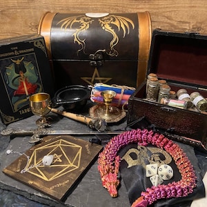 May include: A wooden chest with a dragon design, a set of tarot cards, a pentagram, a cauldron, a set of dice, a dragon-shaped dice bag, and a variety of other magical items.