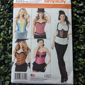 May include: Simplicity pattern 1345 R5 featuring corset designs. The package shows various corset styles in different colors, including red, pink, and orange. The pattern includes sizes 14, 16, 18, 20, and 22. The package is printed in the USA.